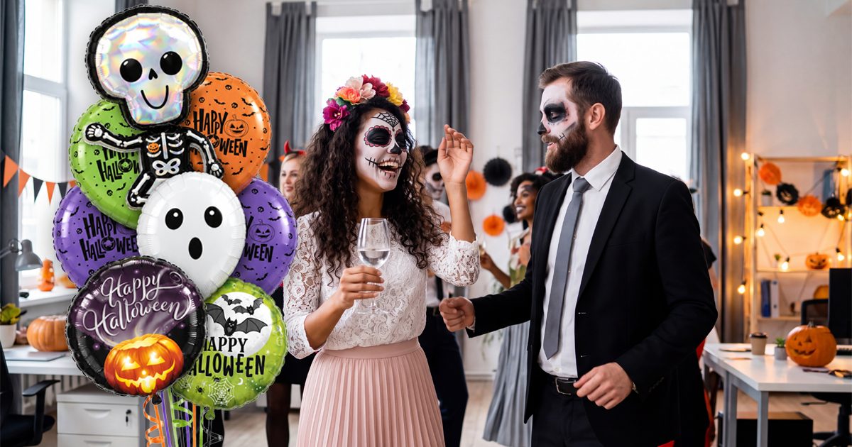 Halloween balloon bouquet beside coworkers in costume at an office Halloween party