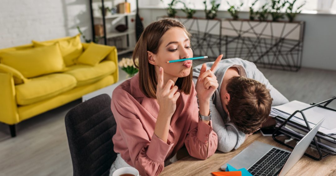 man with head on desk. woman playing with a pencil