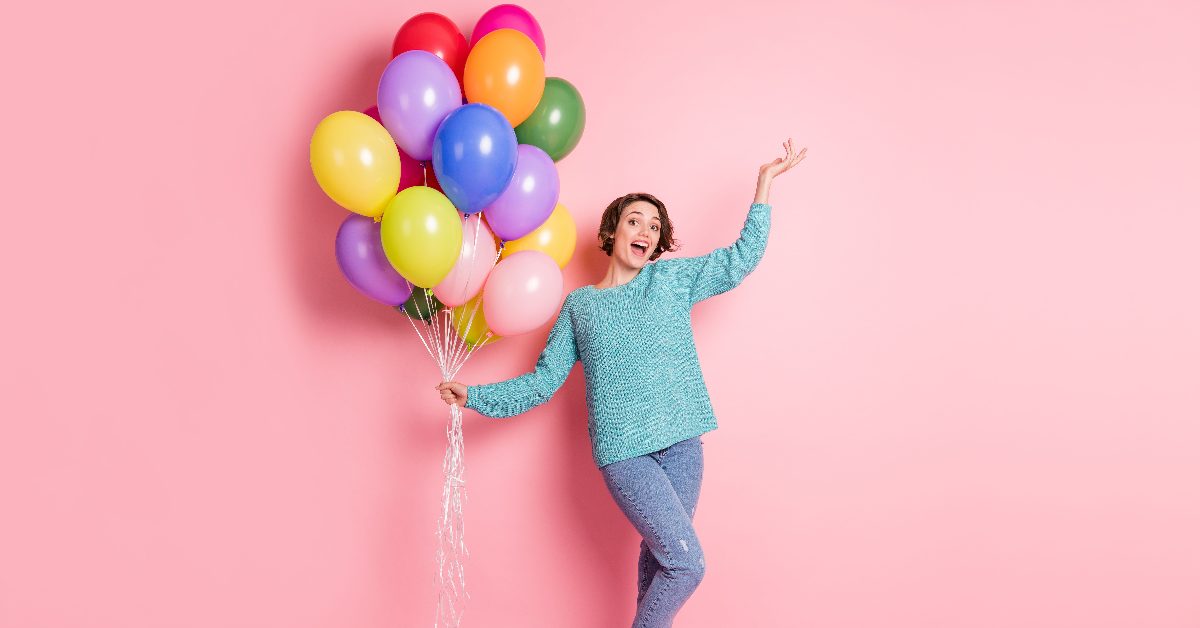 woman holding balloon bouquet